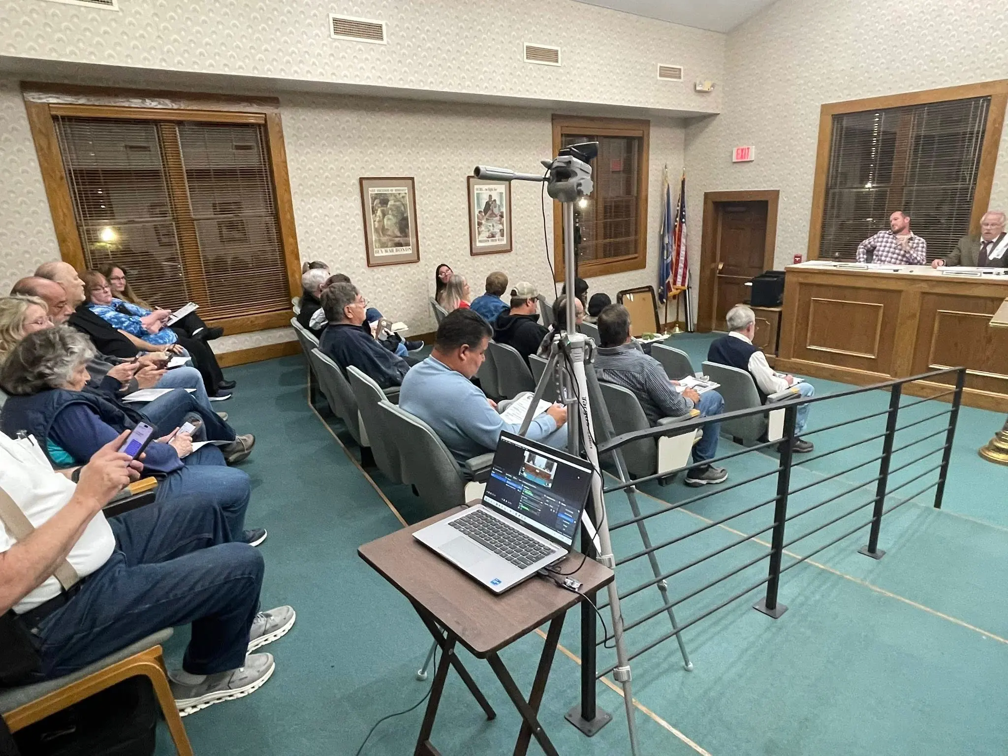 Citizens watching a public meeting online
